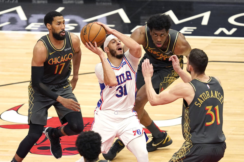 Philadelphia 76ers' Seth Curry (31) drives to the basket as Chicago Bulls forward Garrett Temple (17) Tomas Satoransky (31) and Thaddeus Young defend during the second half of an NBA basketball game Monday, May 3, 2021, in Chicago. (AP Photo/Charles Rex Arbogast)