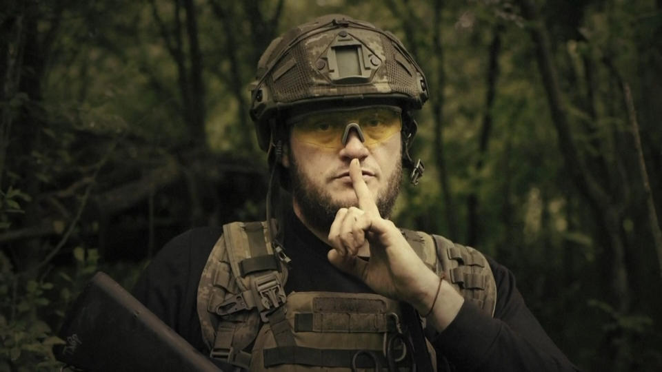 A Ukrainian soldier poses for the camera with his fingers to his lips, in an undisclosed location in Ukraine. (Ukrainian Defense Ministry via AP )