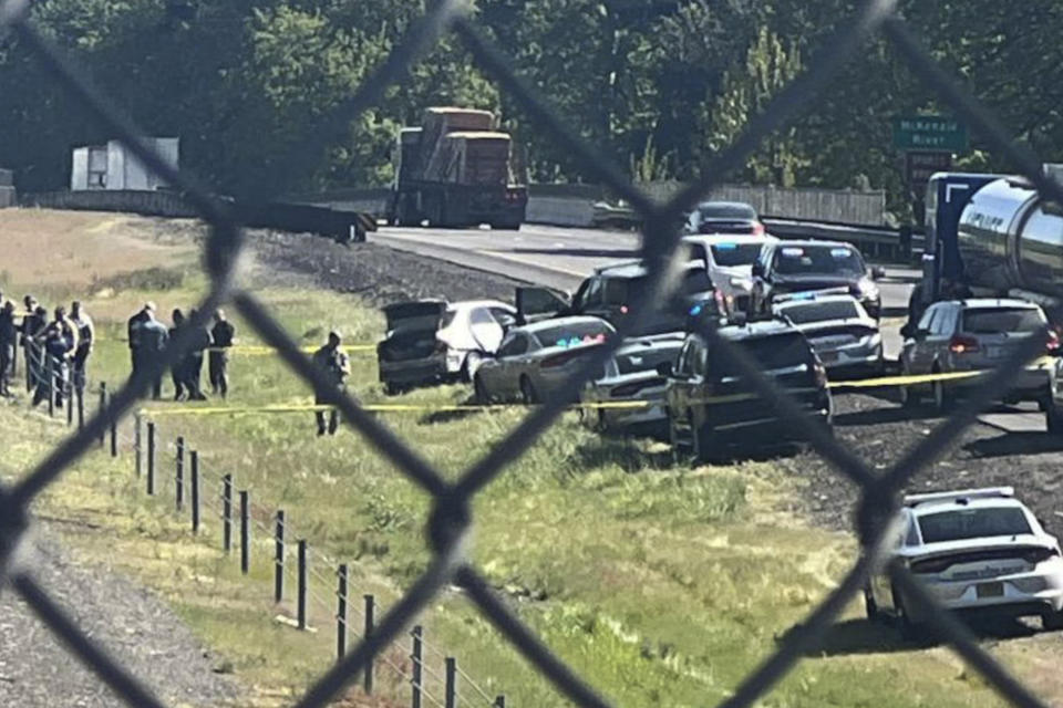 This image provided by KEZI 9 News shows the scene on Interstate 5 on Tuesday, April 23, 2024, near Eugene, Ore., after a former Washington state police officer wanted after killing two people, including his ex-wife, was found with a self-inflicted gunshot wound following a chase in Oregon, authorities said. His 1-year-old baby, who was with him, was taken safely into custody by Oregon State Police troopers. (KEZI 9 News via AP)