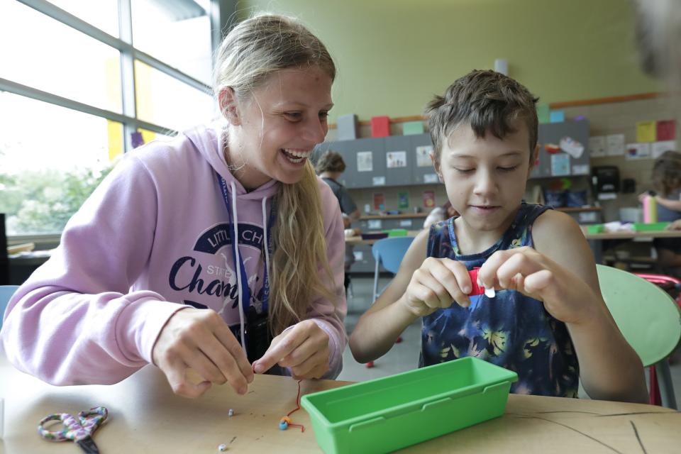 Youth Development Specialist Brynn Morrill, left, and Cayson Anthony make friendship bracelets in the art room at the Boys & Girls Club of Menasha Friday, August 11, 2023, in Menasha, Wis.