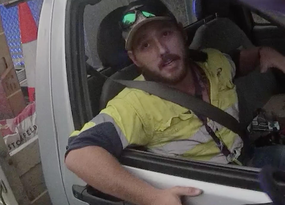 Jimmy sits in a ute on the Dawson Highway west of Calliope.