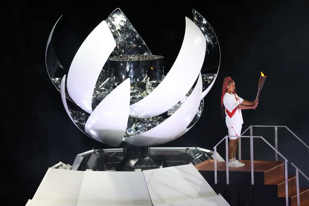 Tennis player Naomi Osaka lights the Olympic Cauldron atop a mini Mount Fuji at the opening ceremony of the Tokyo 2020 Summer Olympic Games. (Photo: Stanislav Krasilnikov via Getty Images)