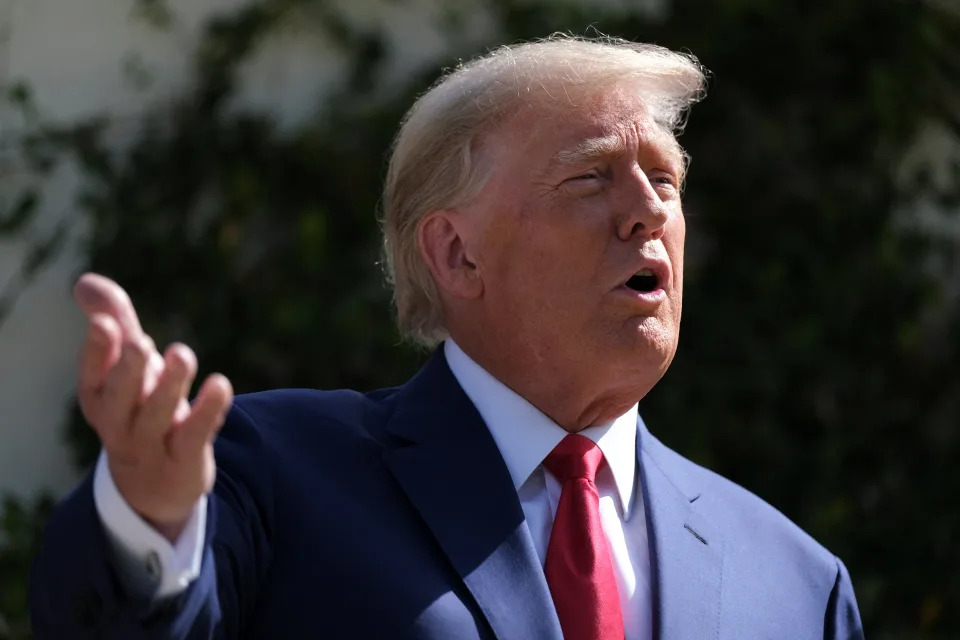 Trump speaks to reporters after voting in the midterms in Palm Beach, Florida, on Tuesday 8 November (REUTERS)