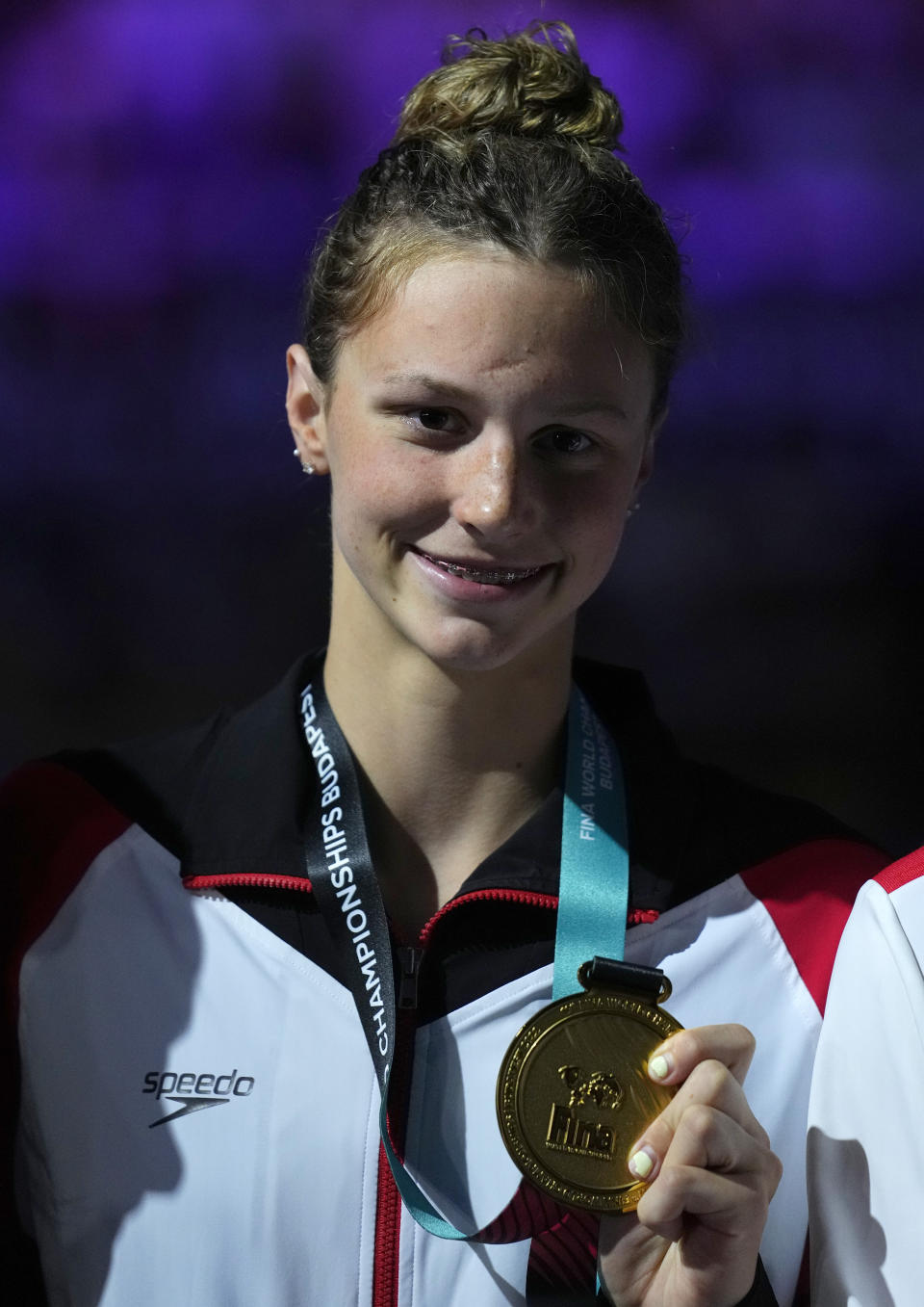 Gold medalist Summer McIntosh of Canada poses with her medal after the Women 200m Butterfly final at the 19th FINA World Championships in Budapest, Hungary, Wednesday, June 22, 2022. (AP Photo/Petr David Josek)