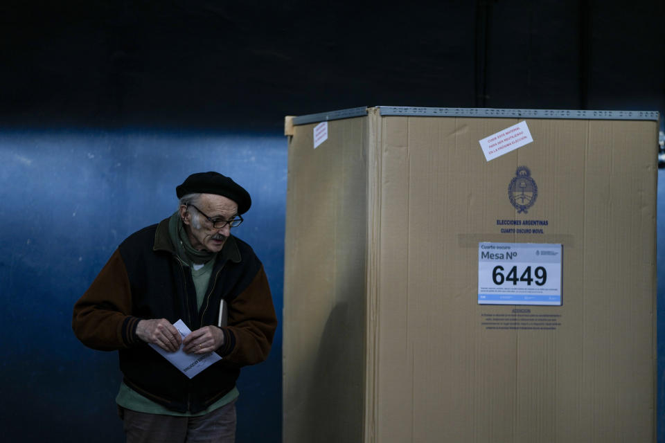 A voter holds his ballot after choosing his preferences during primary elections in Buenos Aires, Argentina, Sunday, Aug. 13, 2023. (AP Photo/Natacha Pisarenko)