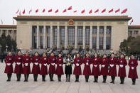 A Chinese journalist poses for photos with hostesses before a preparatory session of the National People's Congress outside the Great Hall of the People in Beijing, Monday, March 4, 2024. (AP Photo/Ng Han Guan)