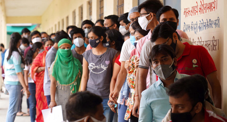 A photo shows vaccine queue in India on Sunday. 