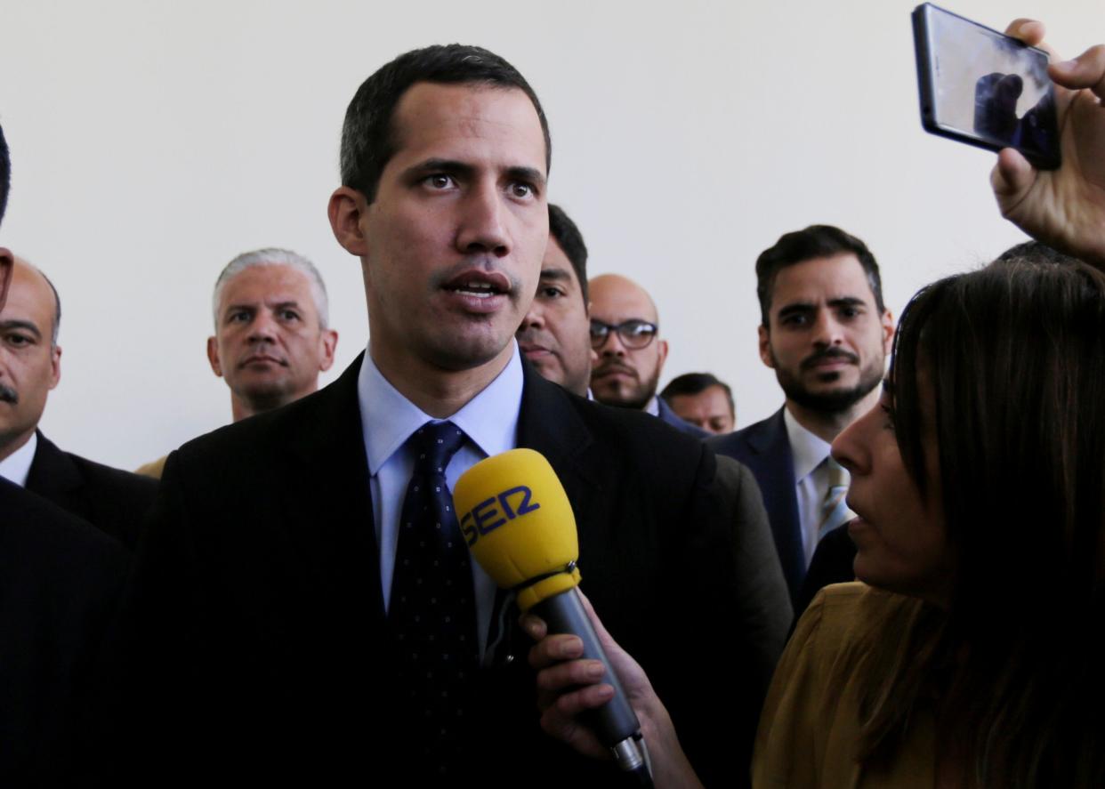 Opposition National Assembly President Juan Guaido, who declared himself interim president of Venezuela, speaks with the media upon his arrival to National Assembly in Caracas on Tuesday. (Photo: Fernando Llano/ASSOCIATED PRESS)