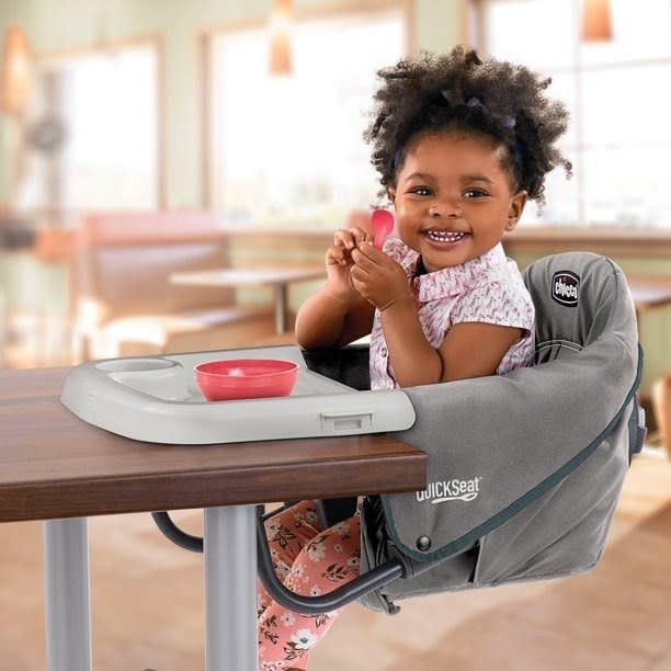 Child sits in booster seat