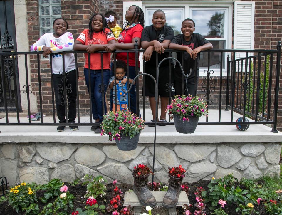 Denise Chandler, 37, of Detroit lost her husband, Richard Chandler when he died March 29 at Sinai-Grace Hospital in Detroit. She poses with six of her eight children behind the memorial garden she planted in his name. Mackenzie Chandler, 8, left,  Kelsey Chandler, 9, Sebastian Ontiveroz, 2, Denise Chandler, 37, (holding) Zoe Ontiveroz, 1, Kodie Chandler, 12, Kaleb Chandler, 10.