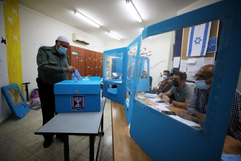 An Arab-Israeli man casts his ballot as he votes in Israel's general election, in Kafr Manda, northern Israel