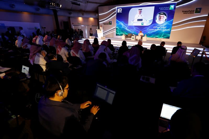 Journalists report from a news conference by Saudi Aramco at the Plaza Conference Center in Dhahran