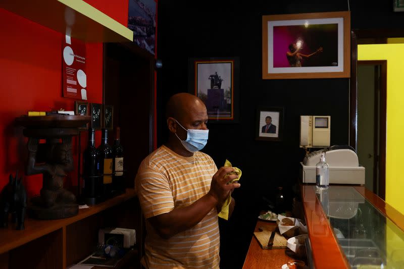 Angolan chef Paulo Soares prepares to serve a table at Casa de Angola restaurant in Lisbon