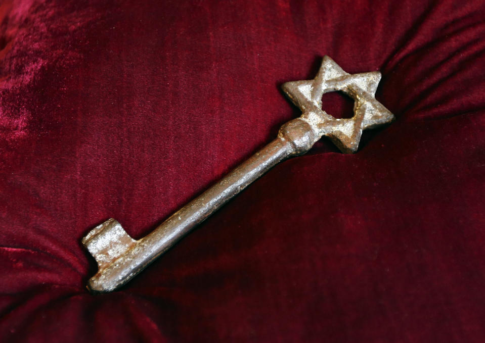 An old metal synagogue key discovered at an open-air street market in Lviv is presented at a ceremony commemorating the 75th anniversary of the annihilation of the city's Jewish population by Nazi Germany in Lviv, Ukraine, Sunday, Sept. 2, 2018. The Ukrainian city of Lviv, once a major center of Jewish life in Eastern Europe, is commemorating the 75th anniversary of the annihilation of the city's Jewish population by Nazi Germany and honoring those working today to preserve that vanished world. The commemoration comes amid a larger attempt in Ukraine to preserve the memories of the prewar Jewish community. (AP Photo/Yevheniy Kravs)