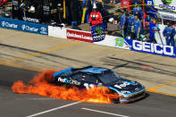 BROOKLYN, MI - JUNE 17: Denny Hamlin drives the #11 FedEx Office Toyota on pit road as it bursts into flames after an incident during the NASCAR Sprint Cup Series Quicken Loans 400 at Michigan International Speedway on June 17, 2012 in Brooklyn, Michigan. (Photo by Drew Hallowell/Getty Images for NASCAR)