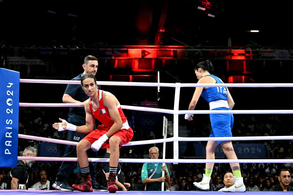 TOPSHOT - Algeria's Imane Khelif (in red) and Italy's Angela Carini leave after their women's 66kg preliminaries round of 16 boxing match during the Paris 2024 Olympic Games at the North Paris Arena, in Villepinte on August 1, 2024. (Photo by MOHD RASFAN / AFP) (Photo by MOHD RASFAN/AFP via Getty Images) ORIG FILE ID: 2164117776