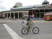 Costumed as Daddy Shark to go with 2-year-old son Finn's baby shark bicycle helmet, Andrew Sullivan rides off on Canal Street in New Orleans for a day of parade-watching on Mardi Gras, Tuesday, Feb. 25, 2020. (AP Photo/Janet McConnaughey)