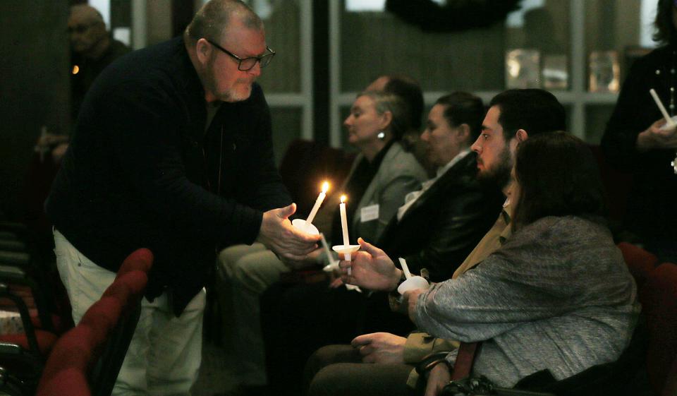 Perry United Methodist Church Poster Jon William lights up candles during a candlelight vigil for the victims of the Perry High School shooting at United Methodist Church on Thursday, Jan. 4, 2023, in Perry, Iowa.