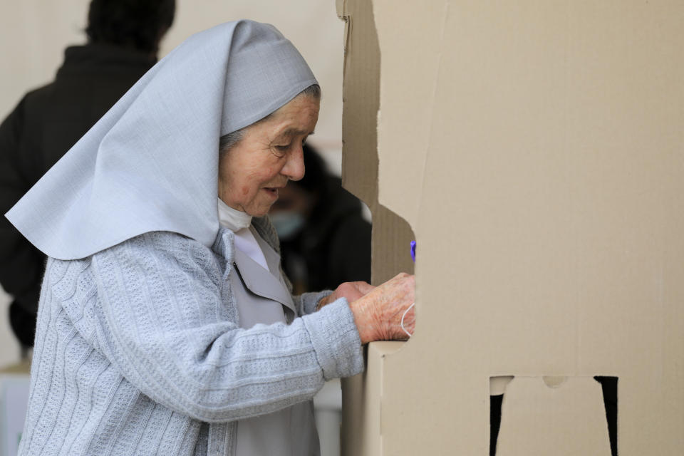 A nun chooses her candidate during a runoff presidential election in Bogota, Colombia, Sunday, June 19, 2022. (AP Photo/Jaime Saldarriaga)