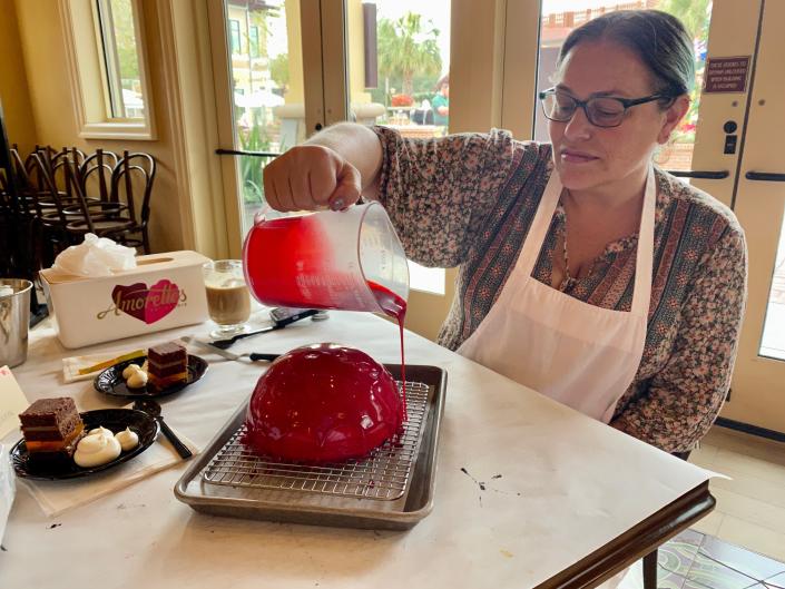 Author&#39;s friend pouring glaze on cake.