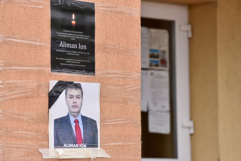 An obituary photo of former mayor Aliman Ion is taped onto the walls of the city hall in Deveselu