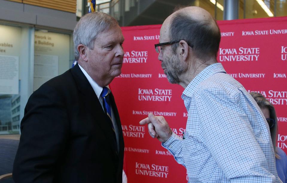 U.S. Secretary of Agriculture Tom Vilsack talks to farm owner Lee Tesdell after an appearance Thursday at Iowa State University.
