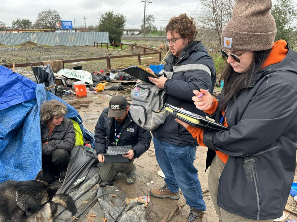 Outreach workers Greg Stupplebeen (from left), John Harding, and Afton Francik, who work for the nonprofit homeless services organization Hope Cooperative, comb the streets of Sacramento searching for homeless people who need housing and services.