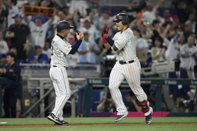 Japan's Kazuma Okamoto (25) celebrates after hitting a home run during fourth inning of a World Baseball Classic championship game against the United States, Tuesday, March 21, 2023, in Miami. (AP Photo/Wilfredo Lee)