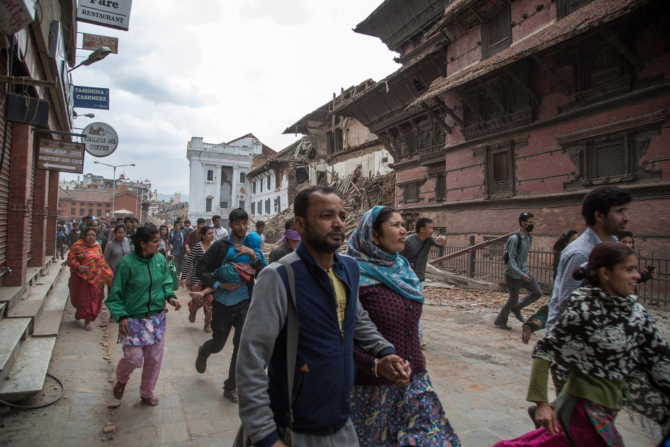 Kathmandu residents run to shelters after a replica tremor hit the city on April 25, 2015. (Omar Havana/Getty Images)