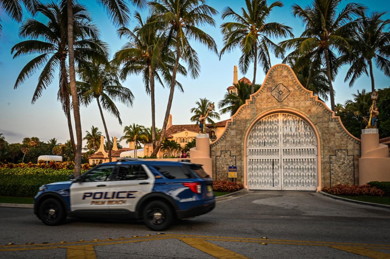 A police car is parked outside the Mar-a-Lago club, the Palm Beach, Fla., home of former President Donald Trump, in April. 