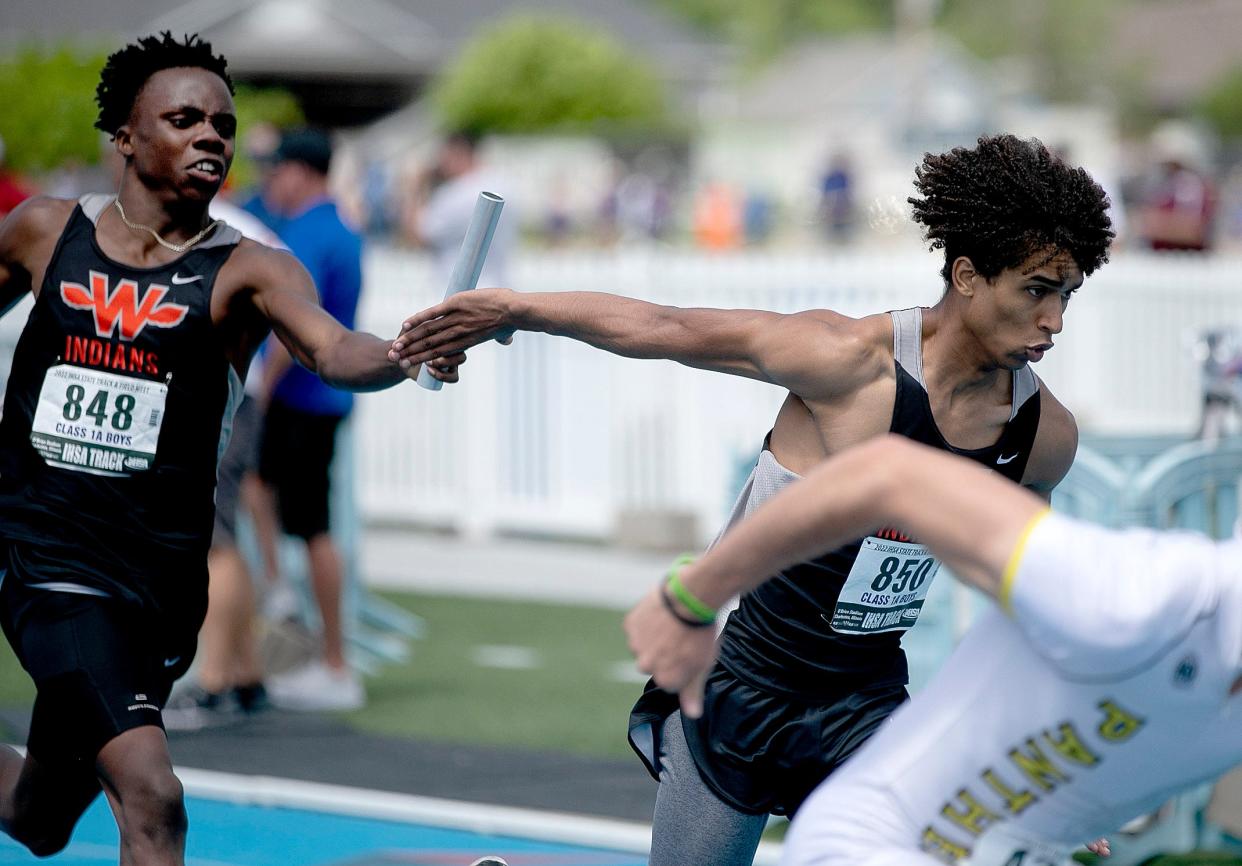 Winnebago's Supreme Muhammad passes the baton to Eden Trotter-Krahn during the 4x200-meter relay at the Illinois High School Association boys track and field state finals Saturday May 28, 2022, in Charleston.