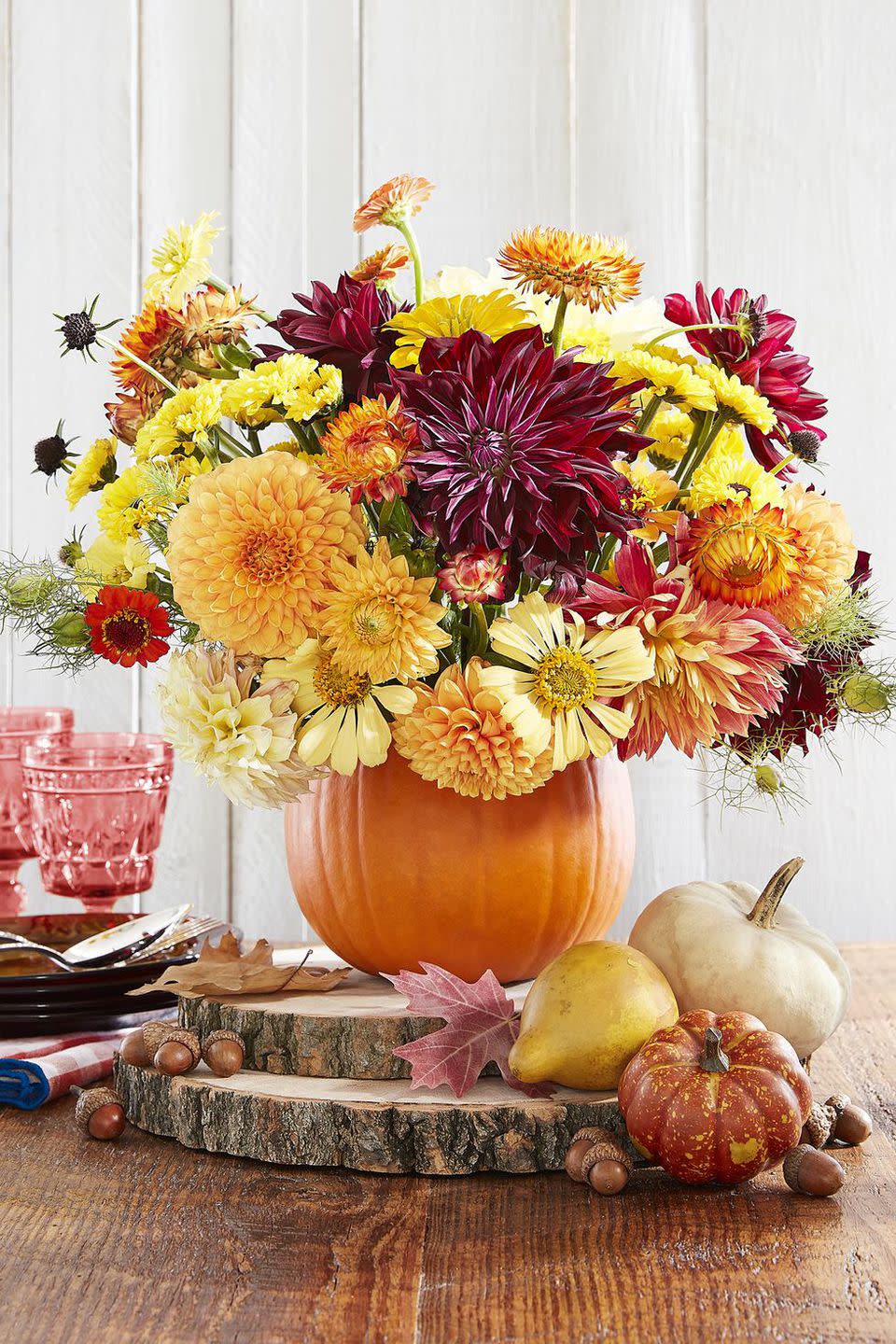 <p>Grab your kids and have them help you transform the star of fall into a beautiful centerpiece. Once you scoop out <a rel="nofollow noopener" href="https://www.womansday.com/home/crafts-projects/g950/funny-pumpkin-carving-ideas/" target="_blank" data-ylk="slk:pumpkin seeds;elm:context_link;itc:0;sec:content-canvas" class="link ">pumpkin seeds</a> and fill with your favorite flowers, place the display on slabs of wood.</p><p><strong>Get the tutorial at <a rel="nofollow noopener" href="https://www.countryliving.com/entertaining/g2130/thanksgiving-centerpieces/?slide=18" target="_blank" data-ylk="slk:Country Living.;elm:context_link;itc:0;sec:content-canvas" class="link ">Country Living.</a> </strong></p><p><strong>What you'll need:</strong> Wood slabs ($13, <a rel="nofollow noopener" href="https://www.amazon.com/Walnut-Hollow-Basswood-Woodburning-Weddings/dp/B00B4F66UI/" target="_blank" data-ylk="slk:amazon.com;elm:context_link;itc:0;sec:content-canvas" class="link ">amazon.com</a>)<strong><br></strong></p>