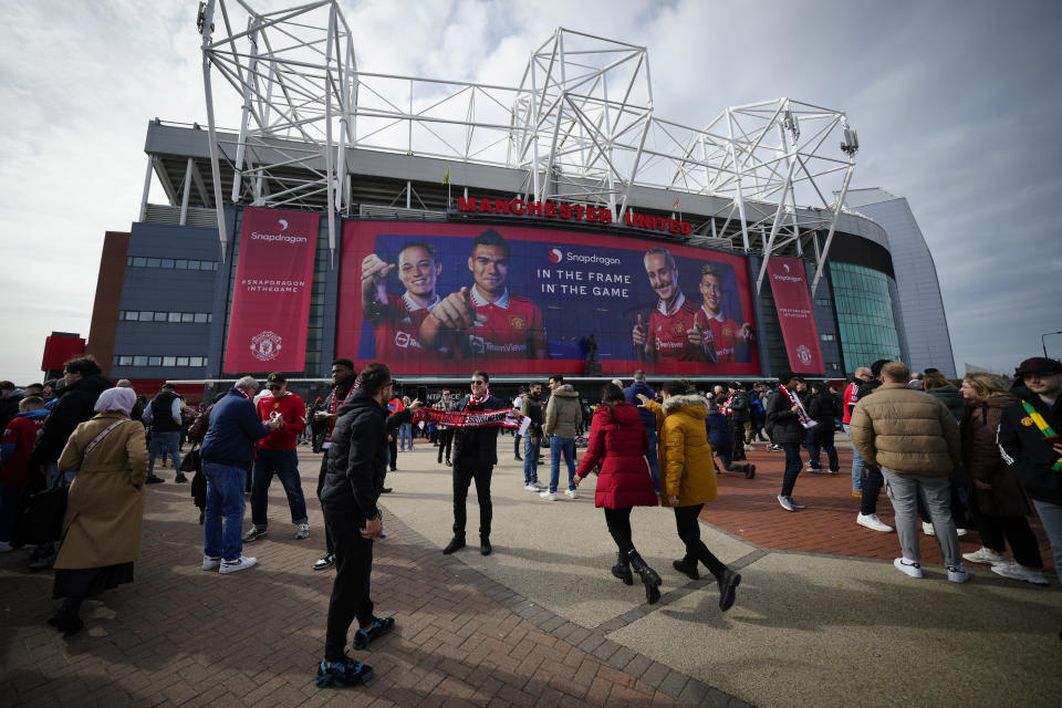 FILE - Fans outside the Old Trafford stadium in Manchester ahead the English Premier League soccer match between Manchester United and Southampton, England, on March 12, 2023. The race to buy Manchester United is taking shape. Based on the publicly declared bids for one of the world's most iconic soccer teams, the frontrunners are Qatari banker Sheikh Jassim bin Hamad Al Thani and local boy-turned-billionaire Jim Ratcliffe. (AP Photo/Jon Super, File)