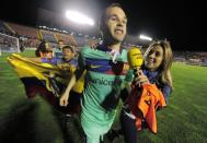 Barcelona's midfielder Andres Iniesta celebrates after the Spanish League football match against Levante at Ciutat de Valencia stadium in Valencia. Barcelona were crowned Spanish champions for the third successive season with a 1-1 draw at Levante clinching a 21st domestic title with two games to spare