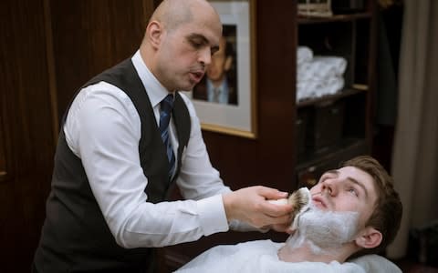 in a lather: Gino Rusu of Truefitt and Hill barbers demonstrates how to use a shaving brush  - Credit: Geoff Pugh for the Telegraph