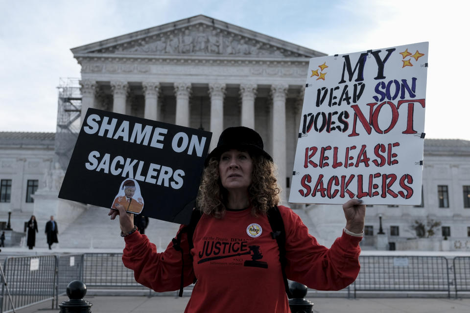 WASHINGTON, US - DECEMBER 4: Grace Bisch hold a picture of stepson Eddie Bisch who died as a result of an overdose on outside of the U.S. Supreme Court on December 4, 2023  in Washington, DC. The Supreme Court heard arguments regarding a nationwide settlement with Purdue Pharma, the manufacturer of OxyContin. The settlement aims to protect the Sackler family, who own the company, from civil lawsuits related to the impact of opioids. (Michael A. McCoy/For The Washington Post via Getty Images)