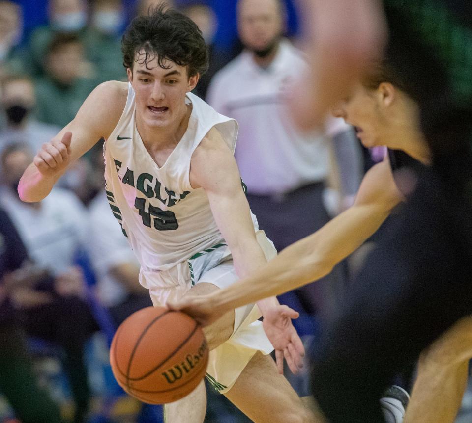 Zionsville High School's Logan Imes (15) goes for a steal at Carmel High School, Tuesday, March 2, 2021, during Zionsville vs. Westfield High Schools' boys sectional.
