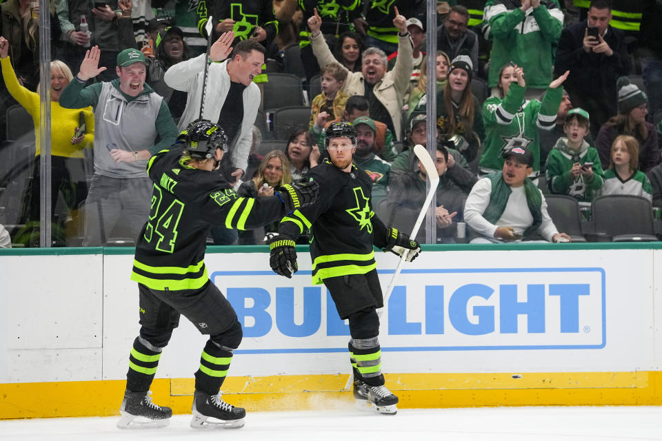 Dallas Stars center Joe Pavelski, right, celebrates his first period goal with center Roope Hintz (24) during an NHL hockey game against the Minnesota Wild, Wednesday, Jan. 10, 2024, in Dallas. (AP Photo/Julio Cortez)