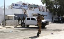 A Somali government soldier walks outside the Central Hotel after a suicide attack in Somalia's capital Mogadishu February 20, 2015. Islamist rebels detonated a car bomb at the entrance of the hotel in the Somali capital on Friday and then stormed inside where politicians had gathered, killing at least 10 people including a lawmaker and lightly wounding two ministers. (REUTERS/Feisal Omar)