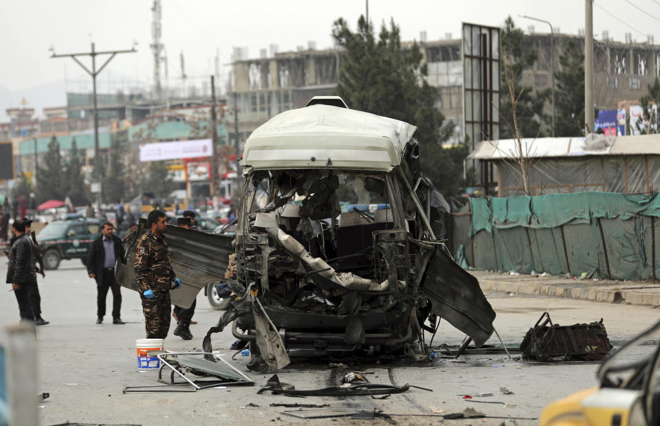 Security personnel inspect the site of a sticky bomb attack in Kabul, Afghanistan, March 15, 2021. Sticky bombs slapped onto cars trapped in Kabul’s chaotic traffic are the newest weapons terrorizing Afghans in the increasingly lawless nation. The surge of bombings comes as Washington searches for a responsible exit from decades of war. (AP Photo/Rahmat Gul)