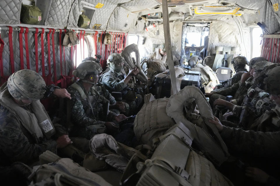 U.S. and Philippine troops ride a U.S. CH-47 helicopter at the Philippines' northernmost town of Itbayat, Batanes province during a joint military exercise on Monday, May 6, 2024. American and Filipino marines held annual combat-readiness exercises called Balikatan, Tagalog for shoulder-to-shoulder, in a show of allied military readiness in the Philippines' northernmost town facing southern Taiwan. (AP Photo/Aaron Favila)