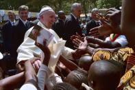 Pope Francis meets with children as he visits a refugee camp in Bangui on November 29, 2015