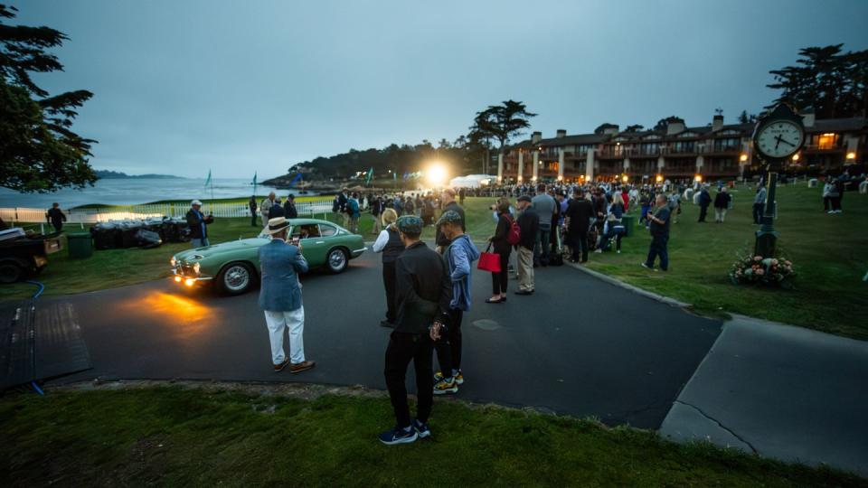 ambiance at pebble beach dawn patrol with green car driving by
