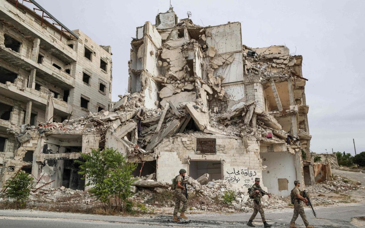 Turkish soldiers patrol along a road past destroyed buildings atop the Arbaeen hill, Idlib (file photo) - OMAR HAJ KADOUR/AFP via Getty Images