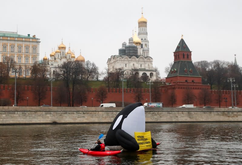 Greenpeace activists take part in a protest in front of the Kremlin against animal rights violations, in Moscow