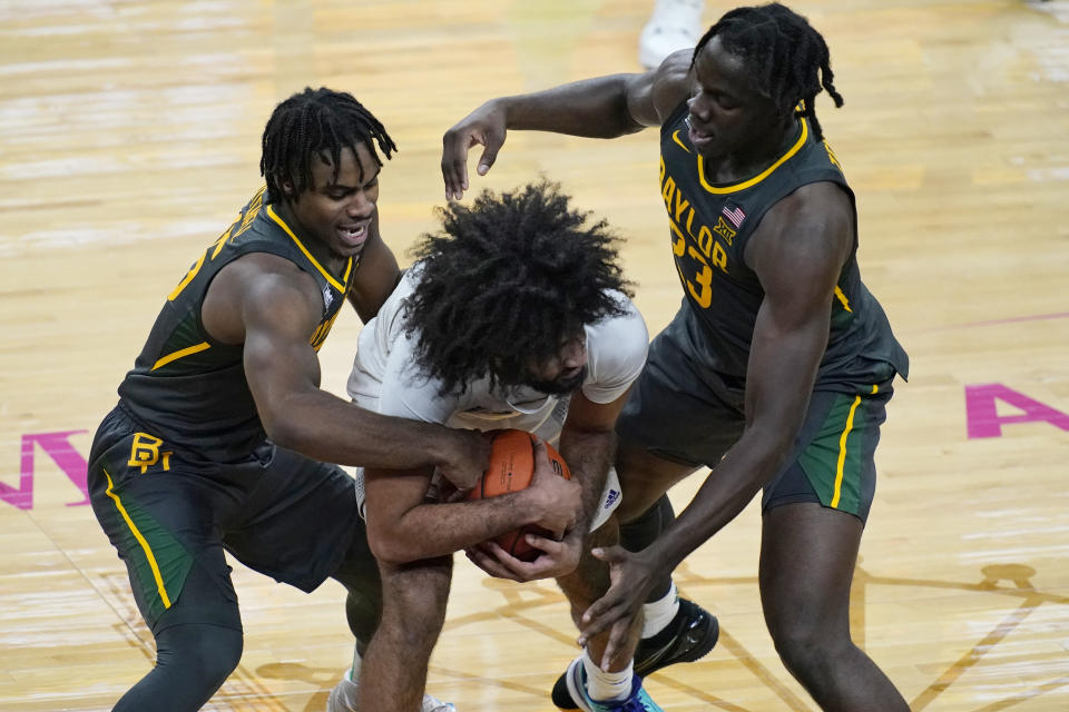 Baylor's Davion Mitchell, left, and Jonathan Tchamwa Tchatchoua, right, guard Washington's Marcus Tsohonis during the second half of an NCAA college basketball game Sunday, Nov. 29, 2020, in Las Vegas. (AP Photo/John Locher)