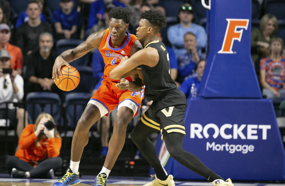 Florida forward Tyrese Samuel (4) drives on Vanderbilt guard Paul Lewis, right, during the first half of an NCAA college basketball game Saturday, Feb. 24, 2024, in Gainesville, Fla. (AP Photo/Alan Youngblood)