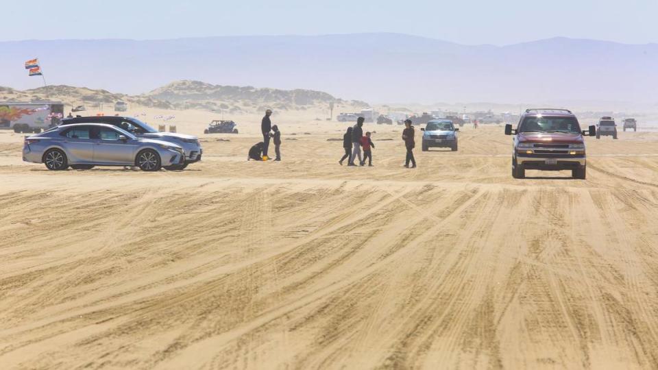 Cars on the Oceano Dunes south of Arroyo Grande Creek on March 22, 2021. A new agreement in December 2021 temporarily lifts a restriction preventing vehicles from crossing the creek any time it’s flowing to the ocean. Now, cars will be allows cars to cross as long as the water is no more than 12 inches deep. The Coastal Commission had voted to ban vehicle crossings of the creek if any amount of water flowed into the ocean. David Middlecamp/dmiddlecamp@thetribunenews.com