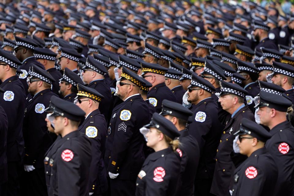 Chicago police and firefighters salute as the body of slain Chicago police officer Ella French is carried into the St. Rita of Cascia Shrine Chapel for a funeral service on Aug. 19, 2021, in Chicago. French was killed and her partner was seriously wounded during an Aug. 7 traffic stop on the city's South Side.