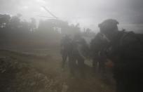 A helicopter arrives to extract National Police from an illegal gold mining operation where they destroyed machinery as part of the Armed Forces' "Operation Guamuez III" in Magui Payan, Colombia, Tuesday, April 20, 2021. Illegal gold mining is common in Colombia, especially wildcat mines in poverty-stricken areas dominated by criminal gangs with little state presence. (AP Photo/Fernando Vergara)